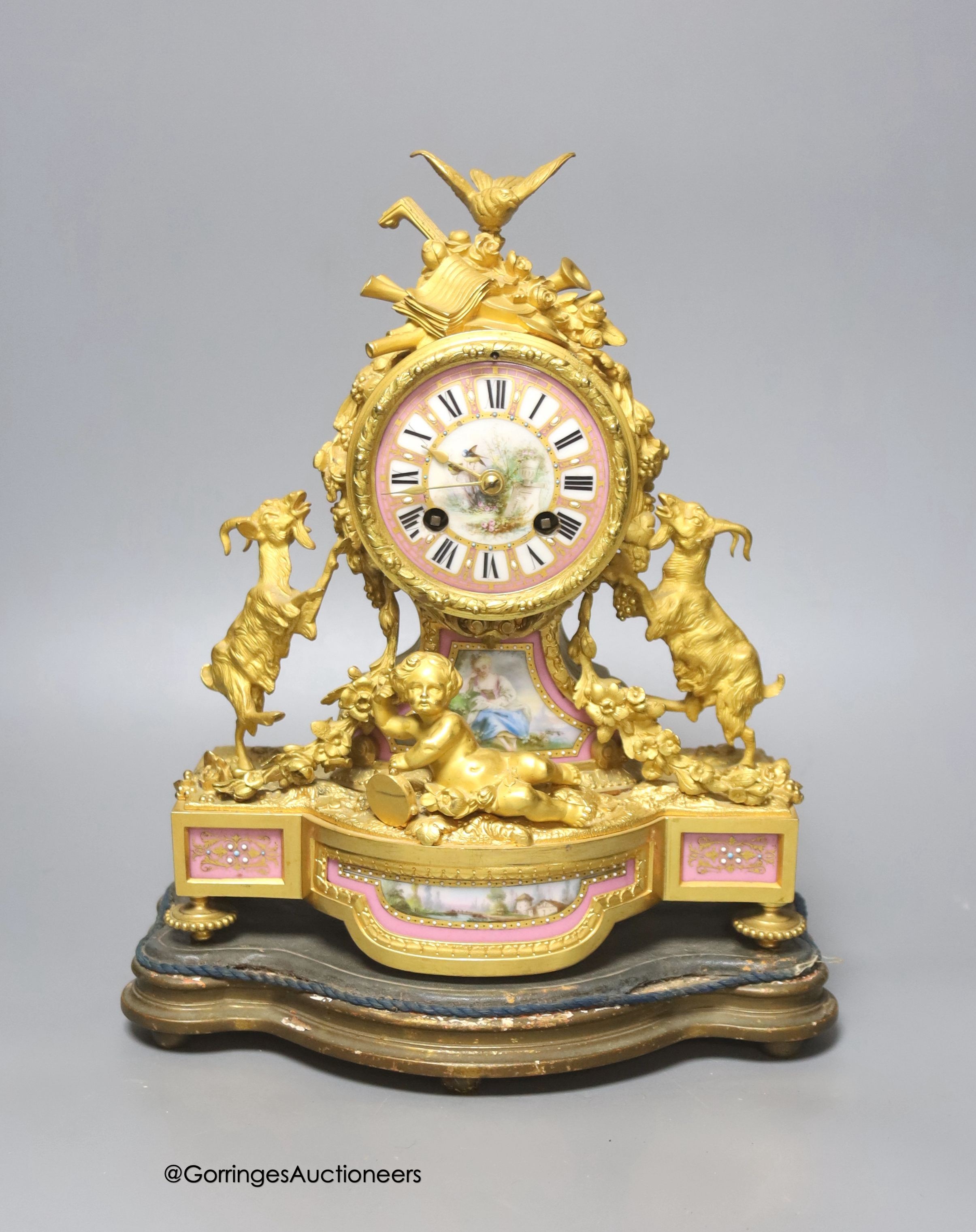 A 19th century French ormolu and porcelain mantel clock, with key and pendulum, overall height 33cm